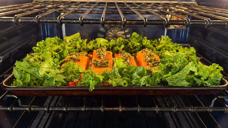 Salmon with mustard greens and chickpeas baking in oven