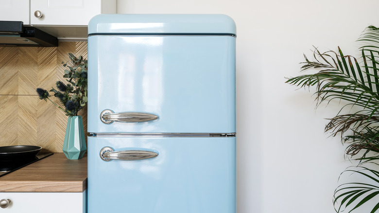 blue refrigerator in white kitchen