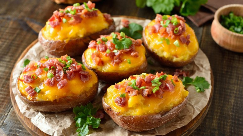 Plate of potato skins with cheese, bacon, and chives