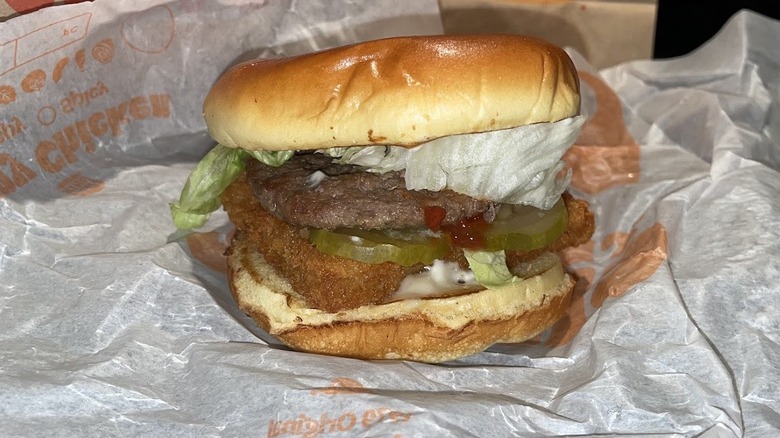 A Big Fish sandwich with a burger patty sits on a wrapper.