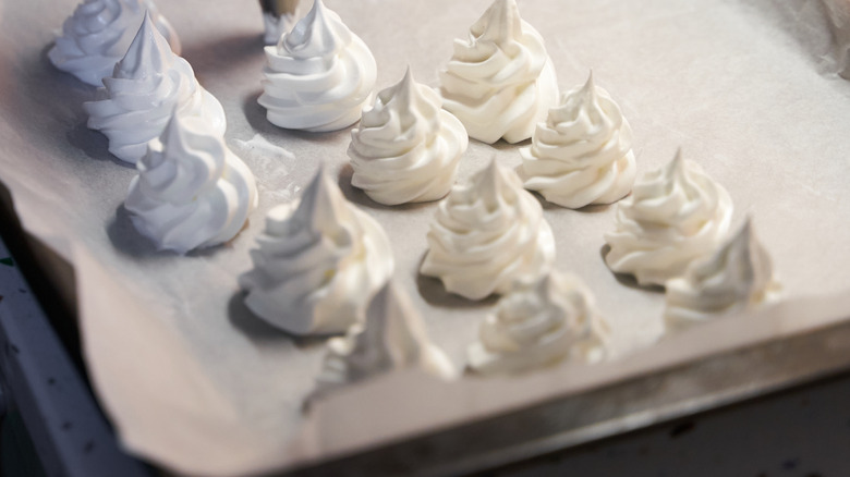 Meringue rosettes on parchment paper