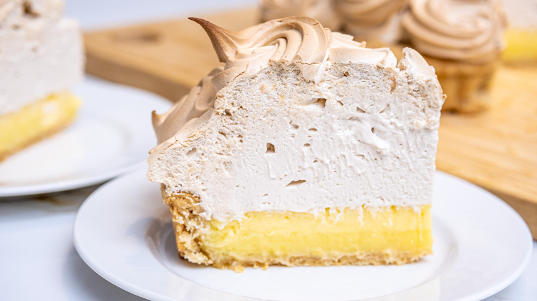 A slice of lemon meringue pie on a plate