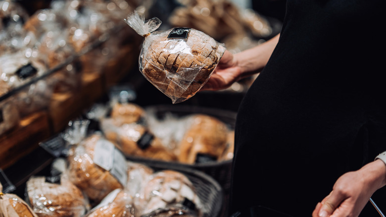 pregant woman browsing packaged bread