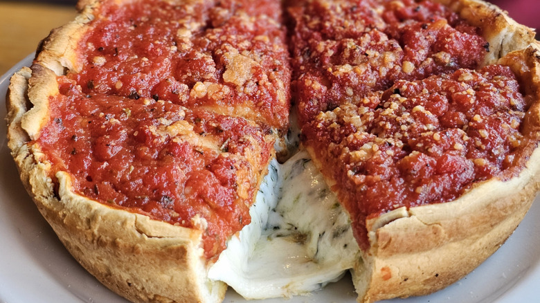 Chicago style deep dish pizza with tomato sauce on top