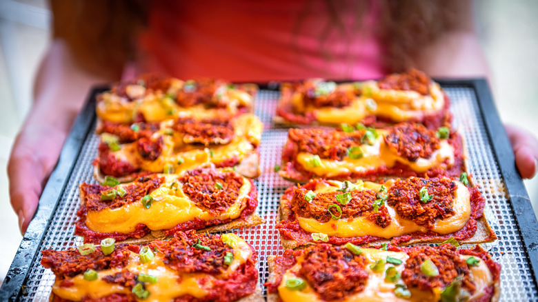 closeup of cracker crust pizzas arranged on tray