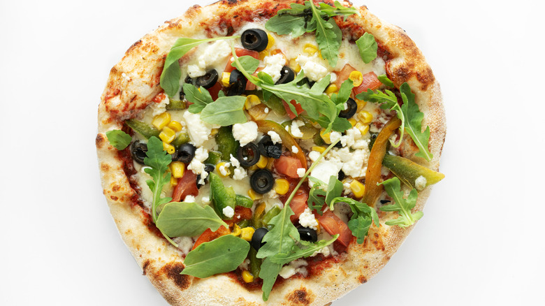 Greek pizza with olives, peppers, and greens