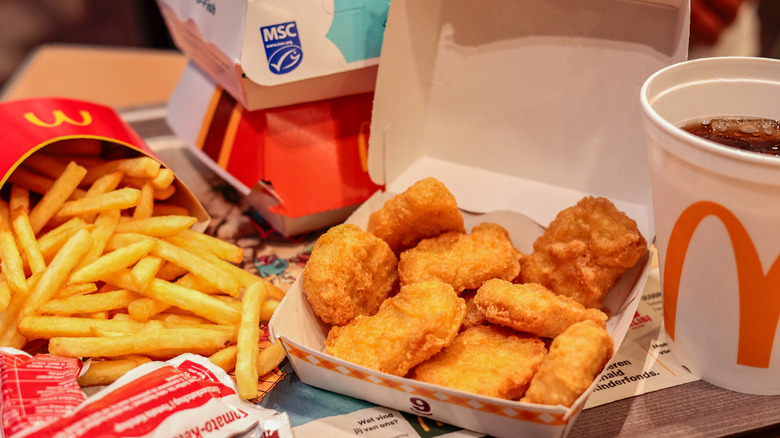 An order of McDonald's McNuggets sits next to fries.