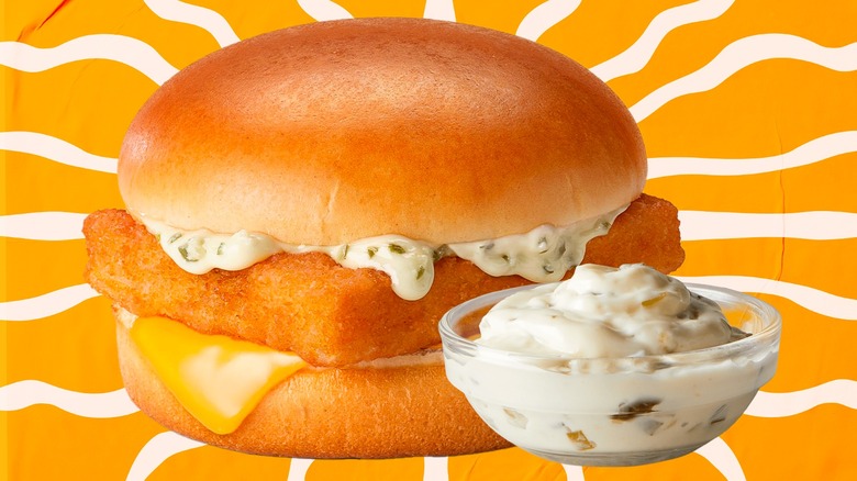 Filet-O-Fish sandwich and small bowl of tartar sauce against an orange and white background