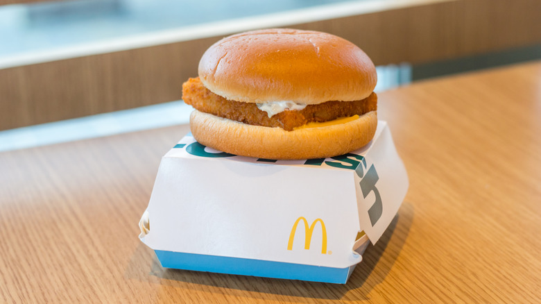 A Filet-O-Fish sandwich on top of its box