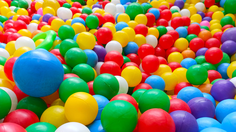 Balls in a ball pit in red, yellow, green, purple, blue, pink, orange, and white