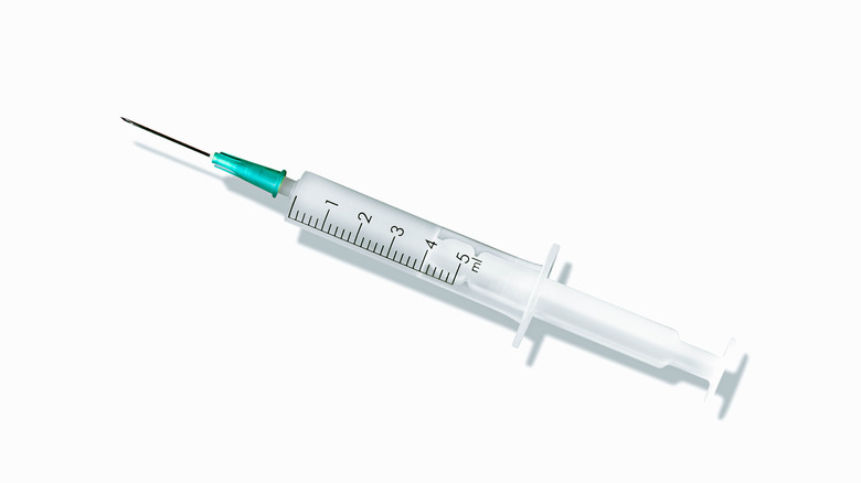 Closeup of a syringe with needle on a white background