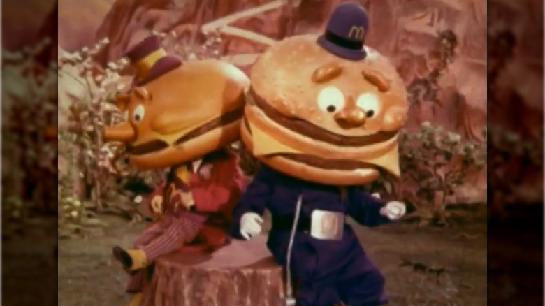 Image from McDonaldland commercial showing Mayor McCheese and Officer Big Mac sitting next to each other