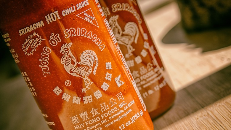 closeup of two Huy Fong Sriracha bottles
