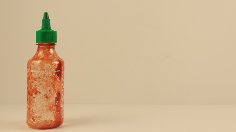 Empty Huy Fong Sriracha bottle
