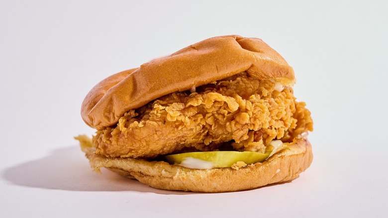 A Popeye's chicken sandwich on table