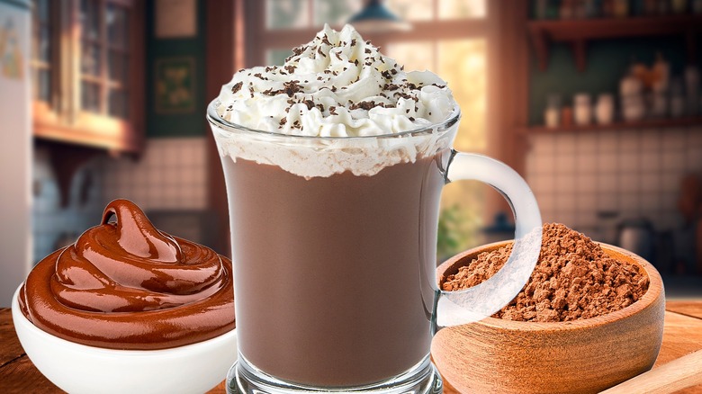 A cup of warm hot chocolate, cocoa powder, and melted chocolate in a bowl