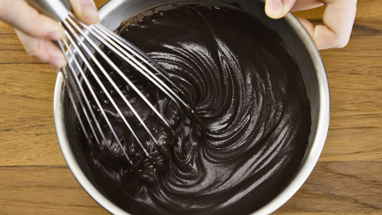 Bowl of chocolate ganache with a whisk