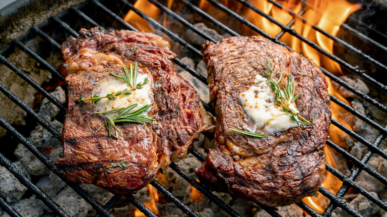 Ribeye steaks on charcoal grill