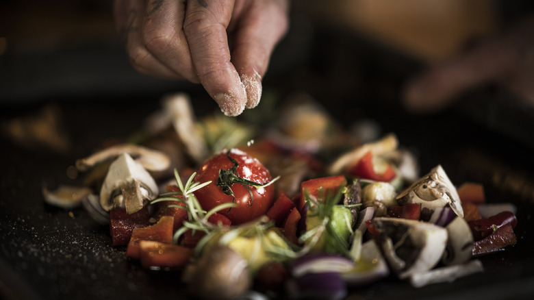 salting vegetables with fingers