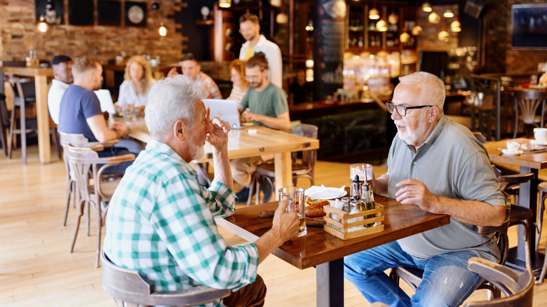 Customers of different ages dine at a restaurant.