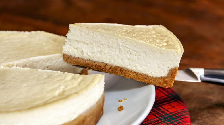 A slice being taken out of a cheesecake