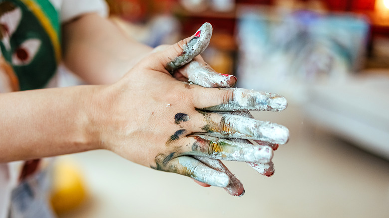 Hands covered in paint