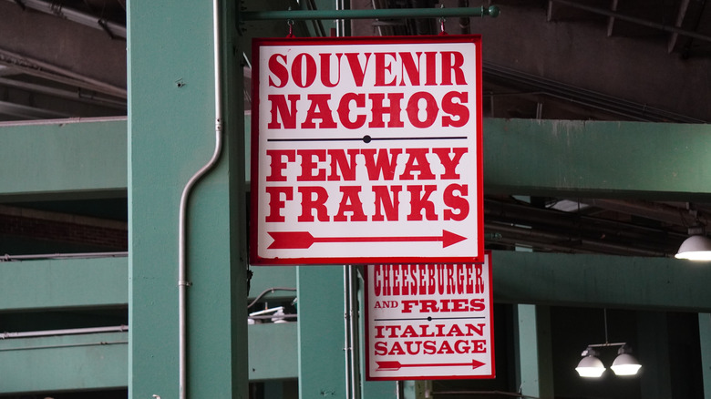 A sign at Fenway Park advertising Fenway Franks, nachos, and souvenirs