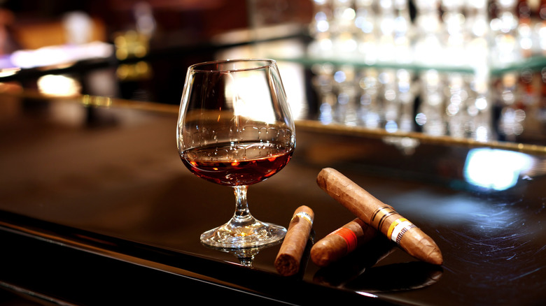 Brandy snifter and cigars at bar