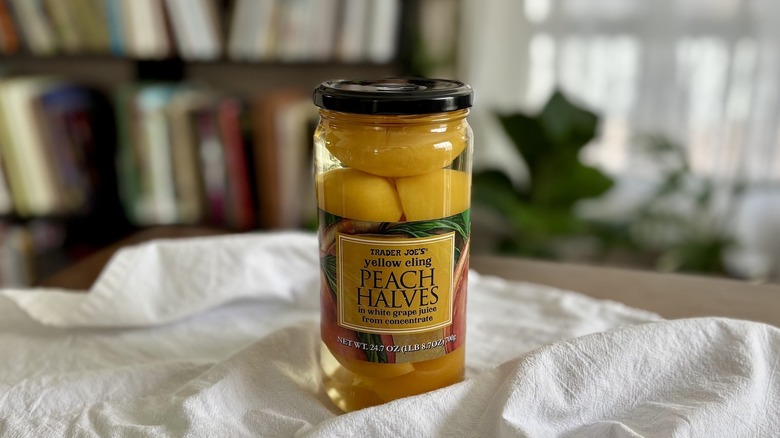 Trader Joe's Yellow Cling Peach Halves on table in front of shelf