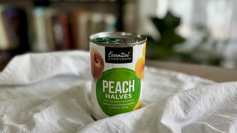 Essential Everyday Peach Slices on table in front of shelf