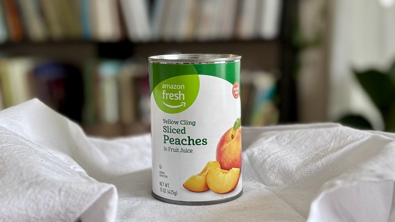 Amazon Fresh Yellow Cling Sliced Peaches on table in front of shelf