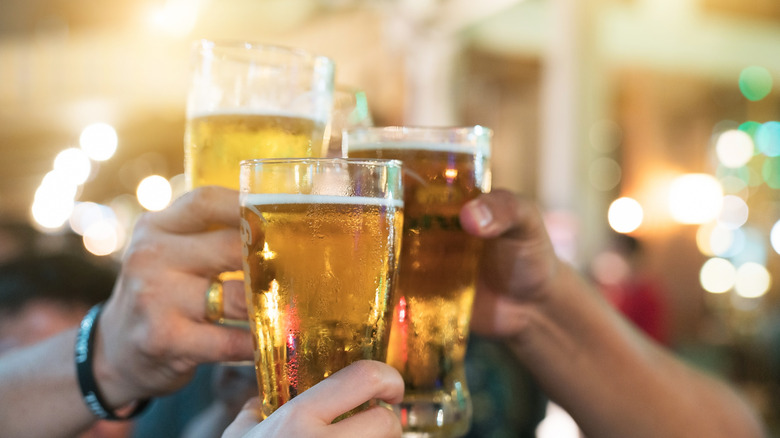 People raising glasses of beer