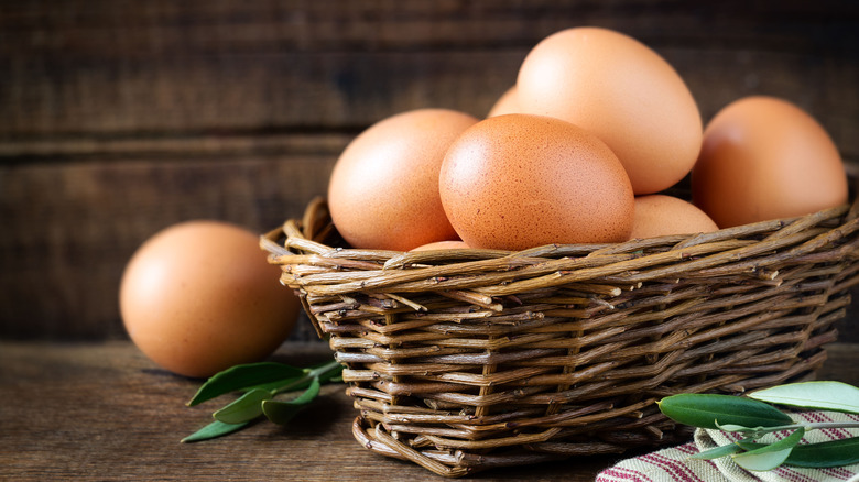 Basket of eggs on cutting board