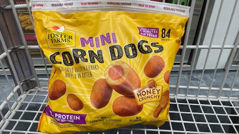 A bag of Foster Farms mini corn dogs in a shopping cart