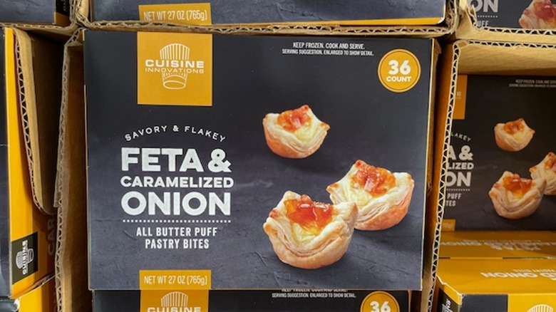 A box of feta and caramelized onion puff pastry bites on the shelf at Costco