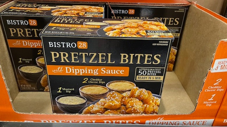 Three boxes of pretzel bites in a display box on the shelf at Costco