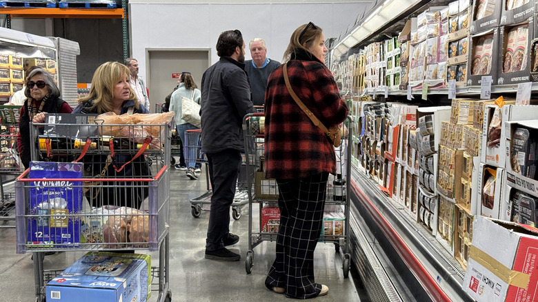 Customers browse through the refrigerated foods section at Costco