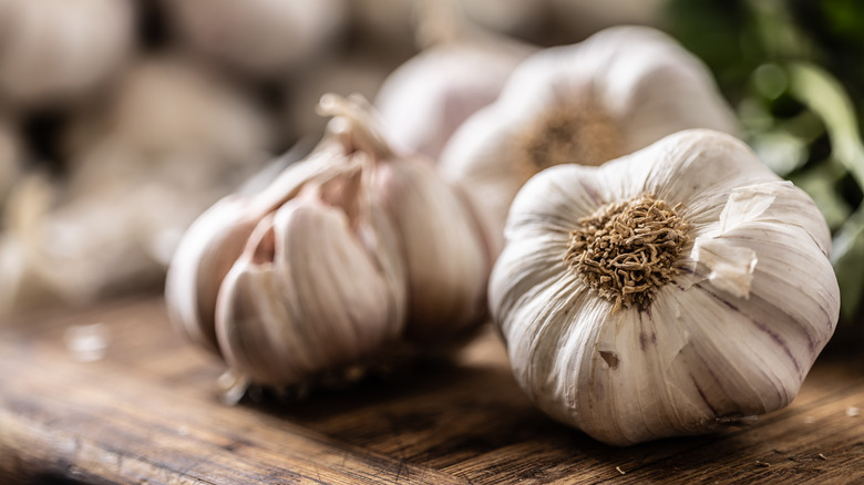 Heads of garlic on cutting board