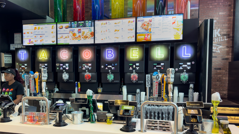 A counter at a Taco Bell Cantina filled with draft beer and frozen drinks