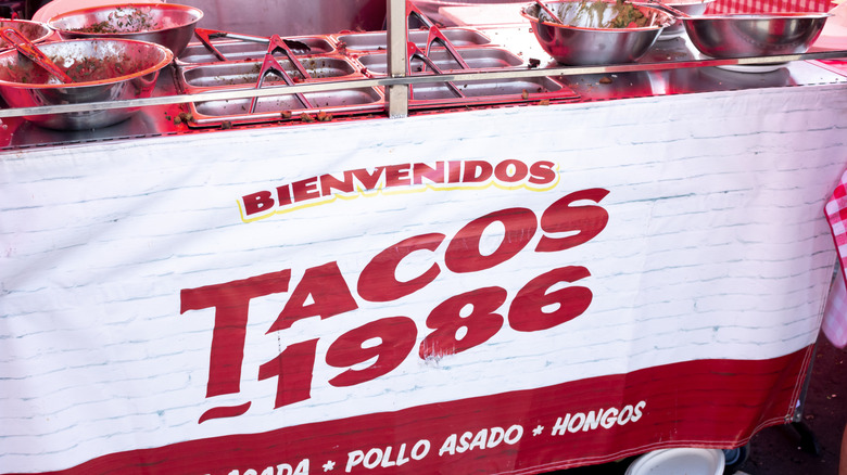 A sign reading "Bienvenidos Tacos 1986"
