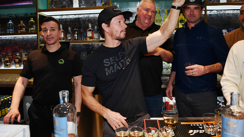 Mark Wahlberg behind a bar at Wahlburgers