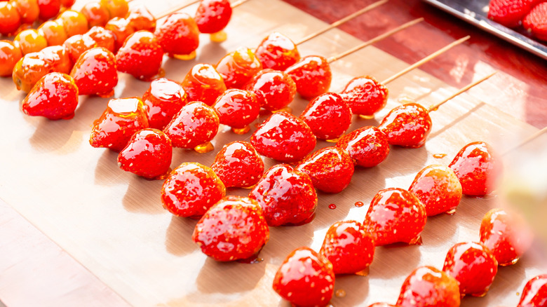 Strawberry tanghulu skewers in a row