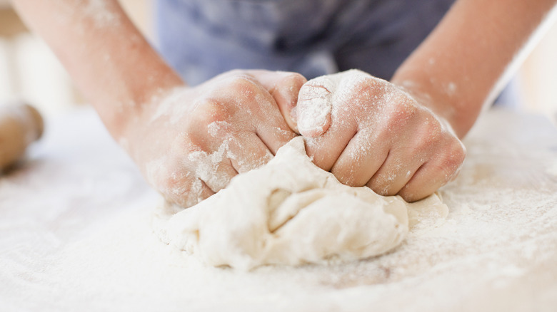 Kneading dough with floured hands