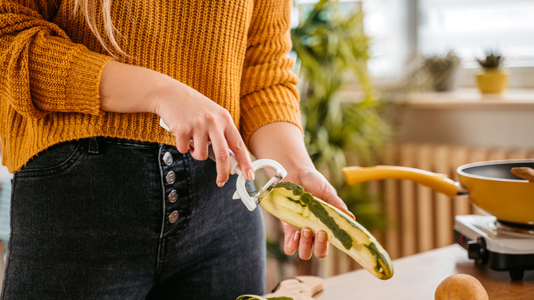 woman peeling zucchini
