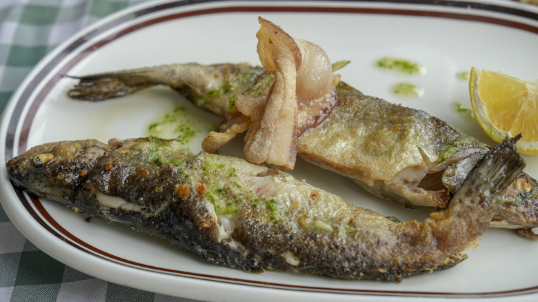 cooked skin-on fish on a plate