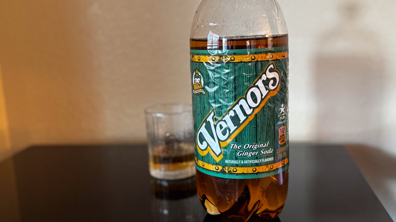 two-liter bottle of Vernors Ginger Ale with a glass of ginger ale blurred in the background