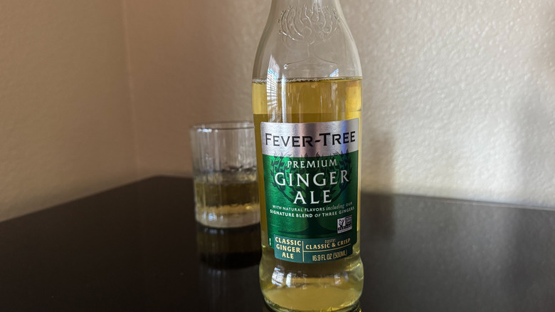 Fever Tree Ginger Ale bottle with blurred glass in the background