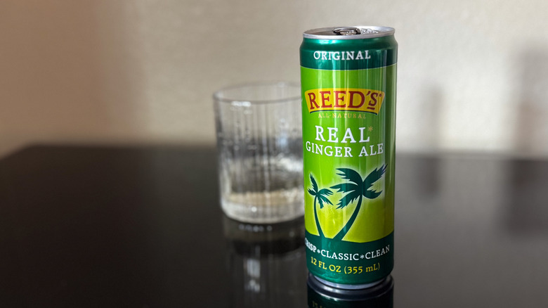 Reed's Ginger Ale can with an almost empty, blurred glass behind it