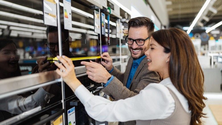 People shopping for an oven