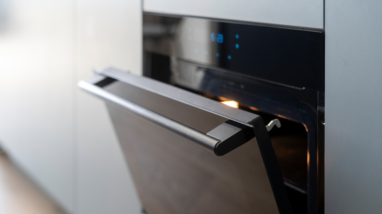 A black oven door left open